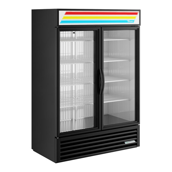 A black glass door merchandiser freezer with LED lighting and two swing doors.