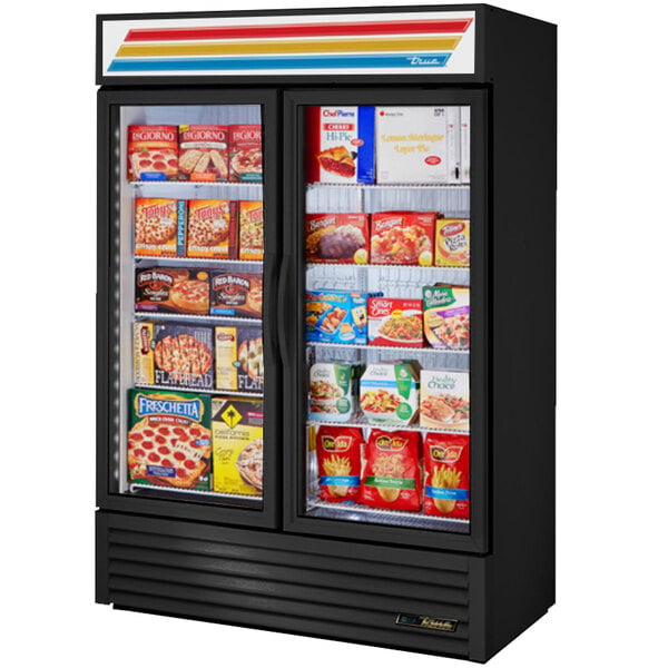 A True glass door merchandiser freezer filled with food.