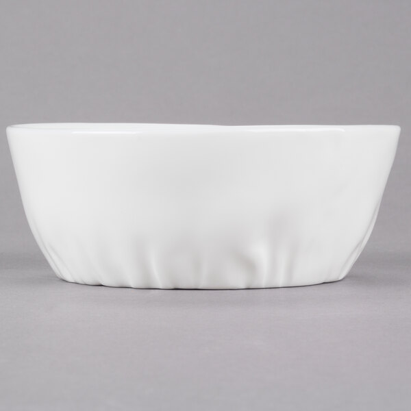 A close up of a 10 Strawberry Street bright white porcelain pinch bowl with a small rim.