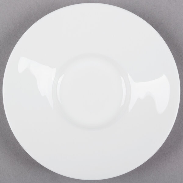 A white Bone China espresso cup and saucer set on a gray surface.