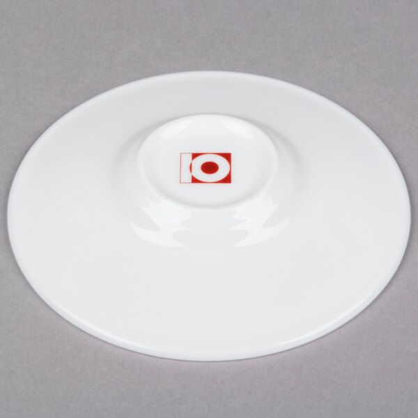 A white bone china espresso cup and saucer with a red circle.