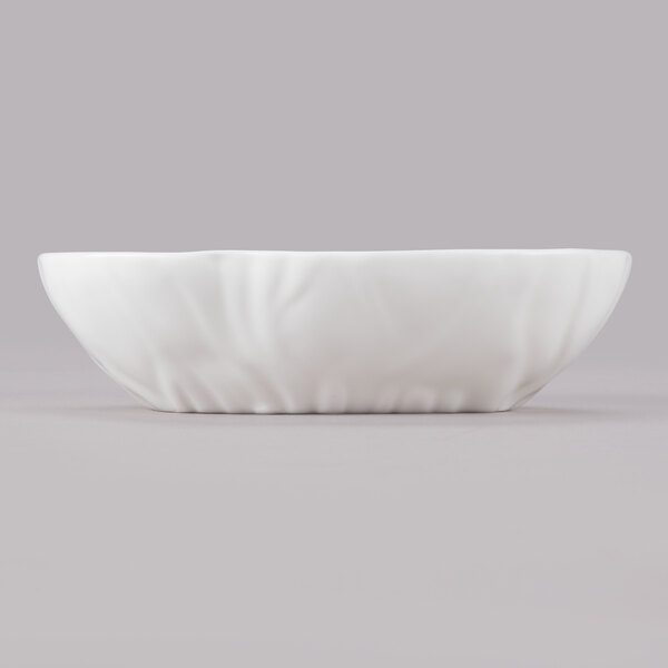 A white large elliptical bowl with a small design on it.