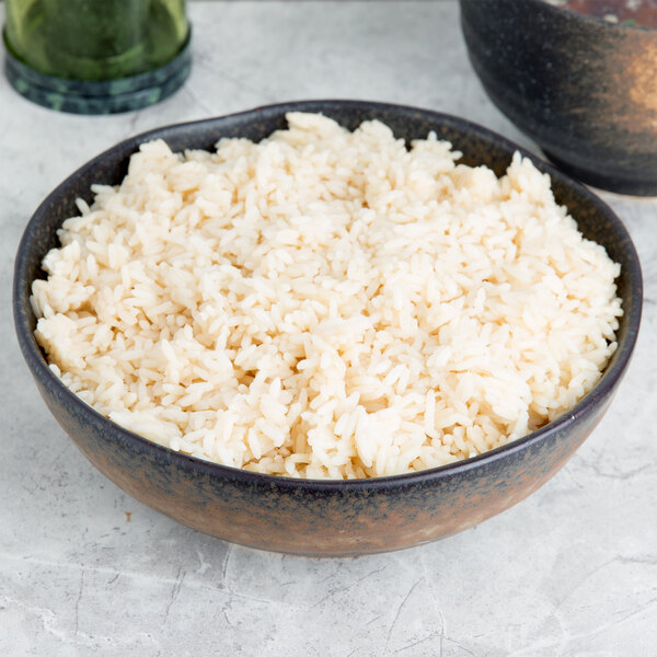 A 10 Strawberry Street Whittier stoneware serving bowl filled with rice on a table.