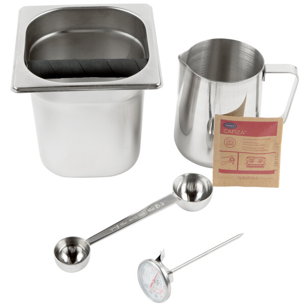 A metal container of Urnex Cafiza powder with a handle and measuring spoon inside.