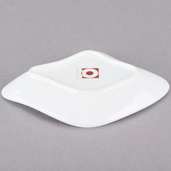 A white 10 Strawberry Street porcelain plate with a red circle on it.