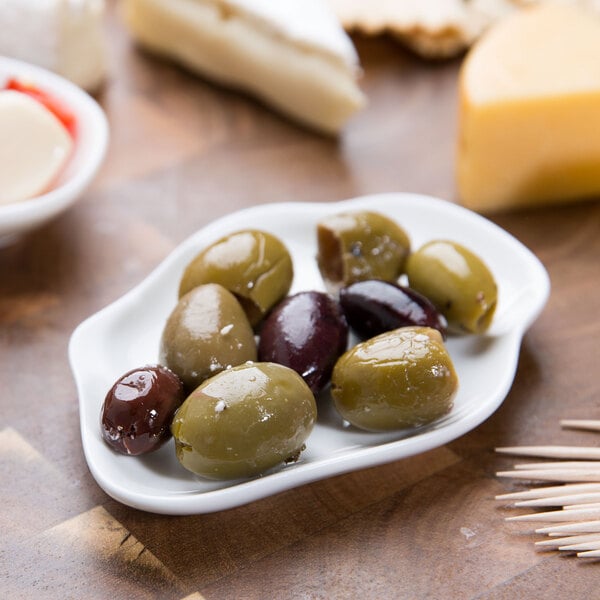 A 10 Strawberry Street bright white porcelain plate with olives and cheese.