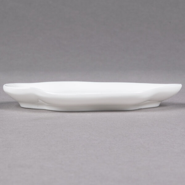 A close up of a 10 Strawberry Street Bright White Porcelain Plate with a curved edge.