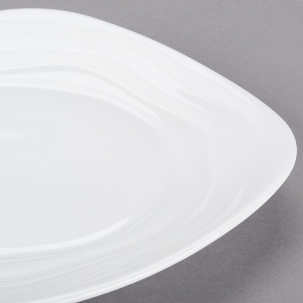 A white square porcelain side plate with a wavy design.