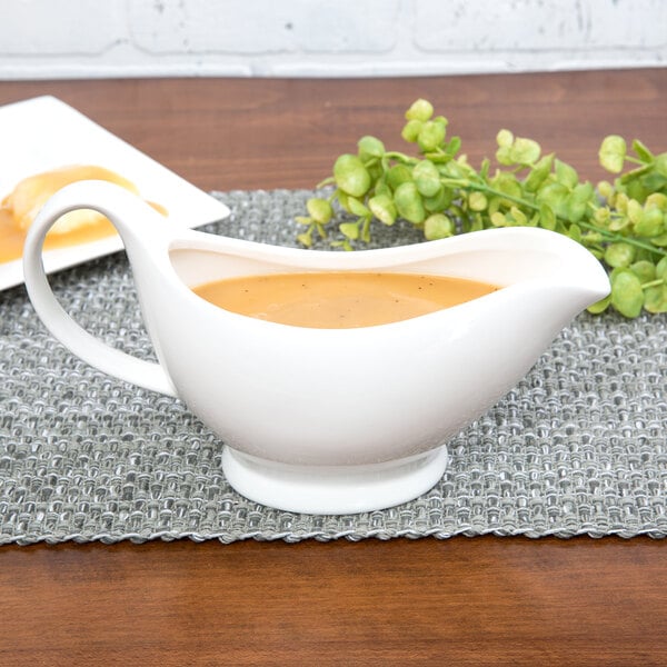 A white 10 Strawberry Street porcelain gravy boat on a white background.