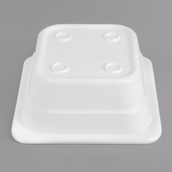 A white plastic Thunder Group food pan with holes in the top.