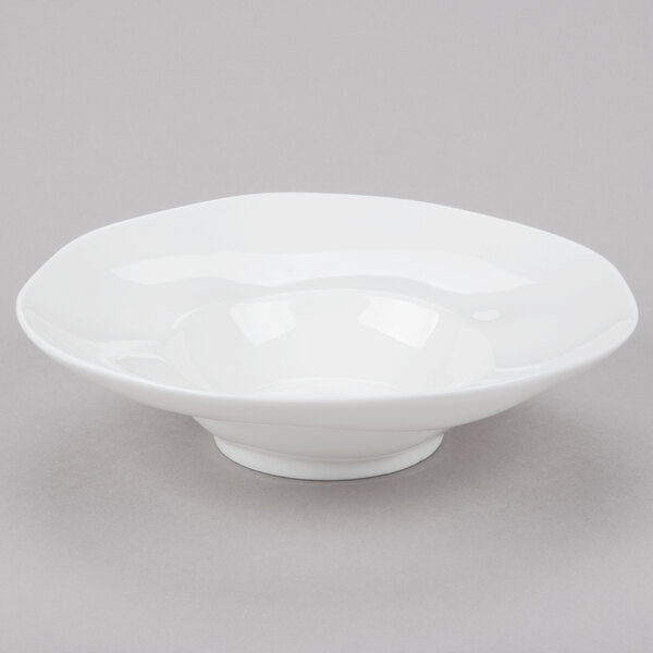 A 10 Strawberry Street bright white porcelain pasta bowl with a small rim on a gray surface.