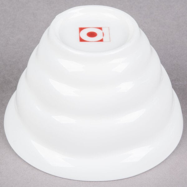 A bright white porcelain bowl with a red circle on top.