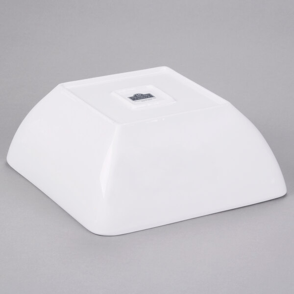 A white square Whittier porcelain bowl with a logo on it.