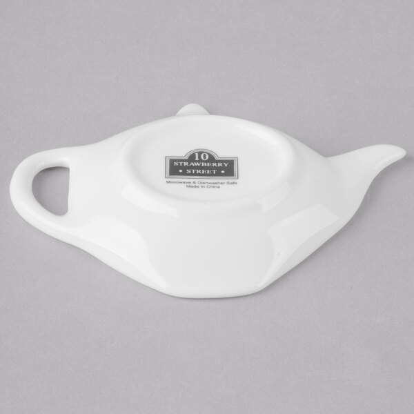 A white porcelain teabag holder with the 10 Strawberry Street logo.