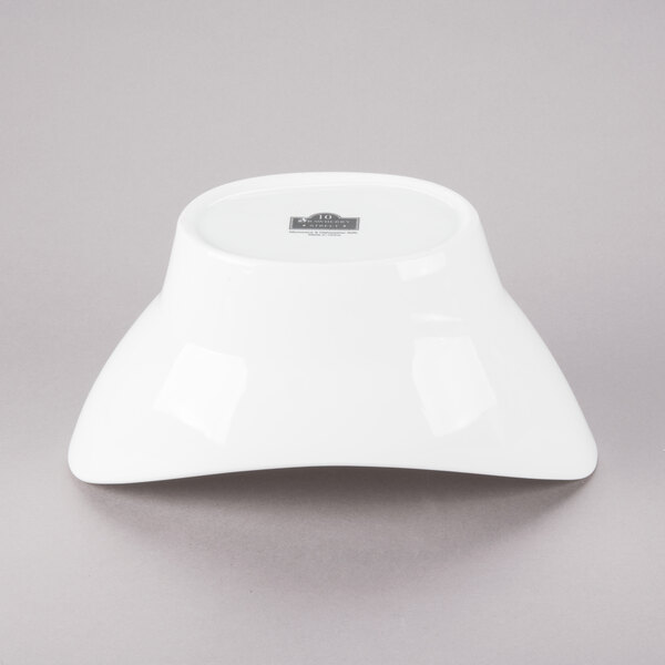 A white 10 Strawberry Street Whittier oval porcelain bowl with a lid on top.