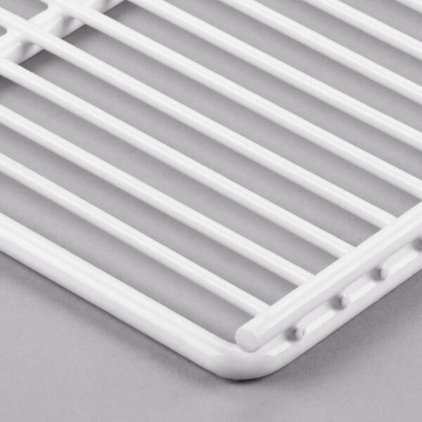 A white coated wire shelf with a metal grid.