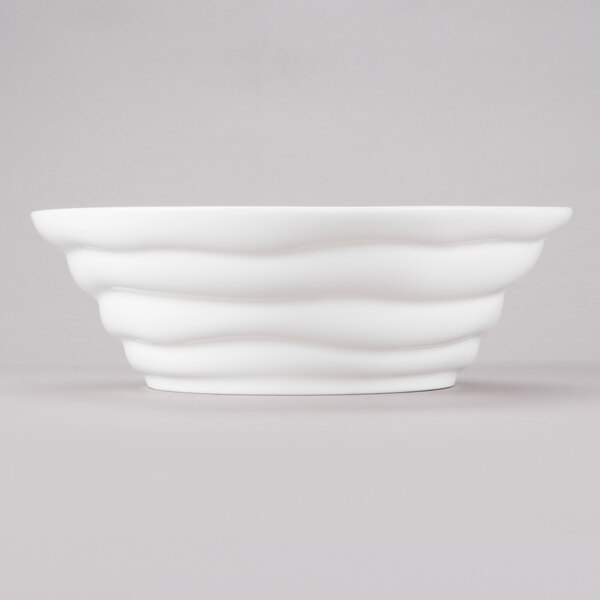 A white porcelain bowl with wavy lines.