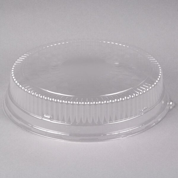 A clear plastic round high dome lid with a small hole in it.