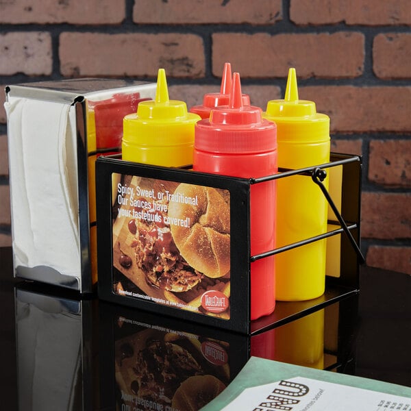 A Tablecraft black powder-coated caddy holding condiments and napkins.