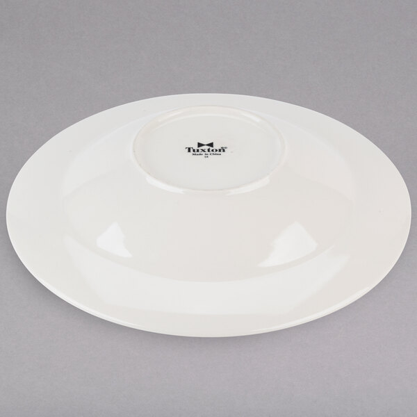 A white Tuxton pasta bowl with a black rim.