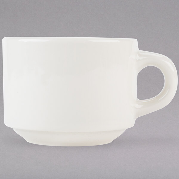 A Tuxton white china cup with a handle.