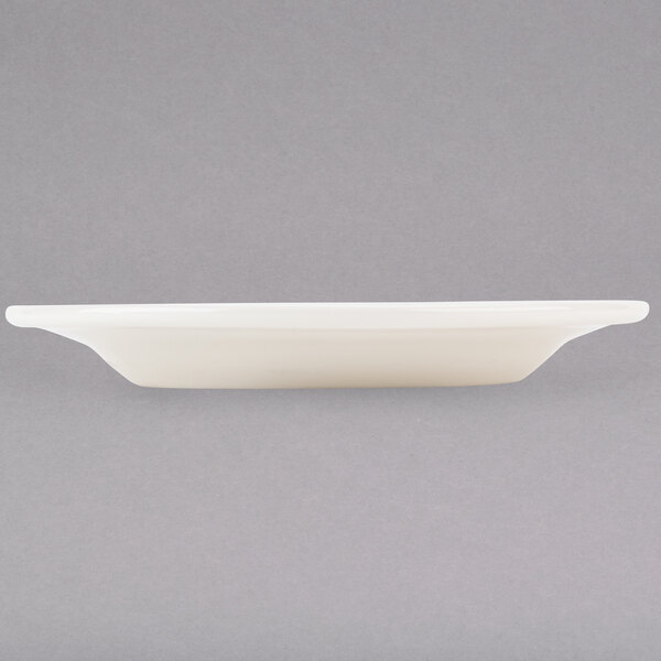 A Tuxton Reno eggshell white china plate on a white background.