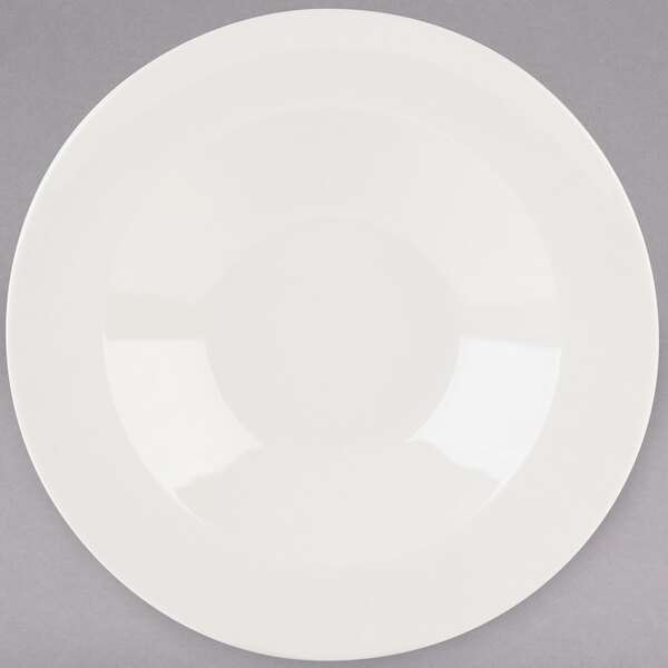 A white Tuxton pasta bowl with a white rim.