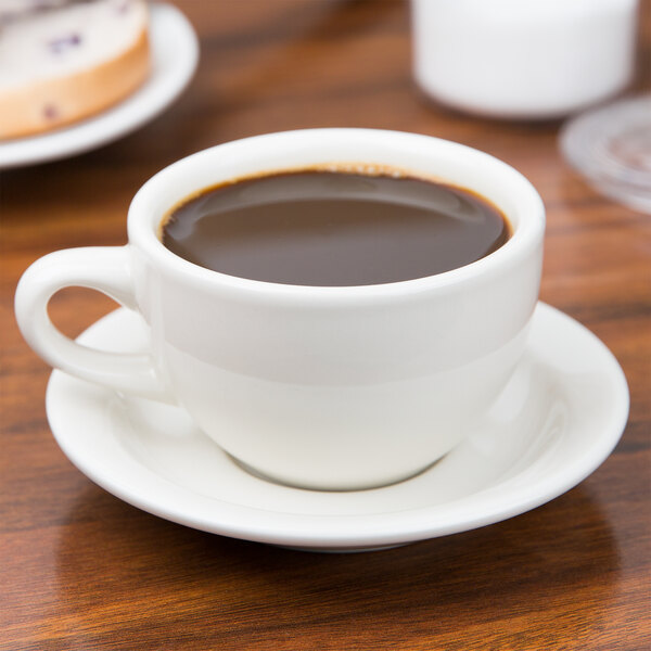 A Tuxton Nevada eggshell china cup on a saucer.