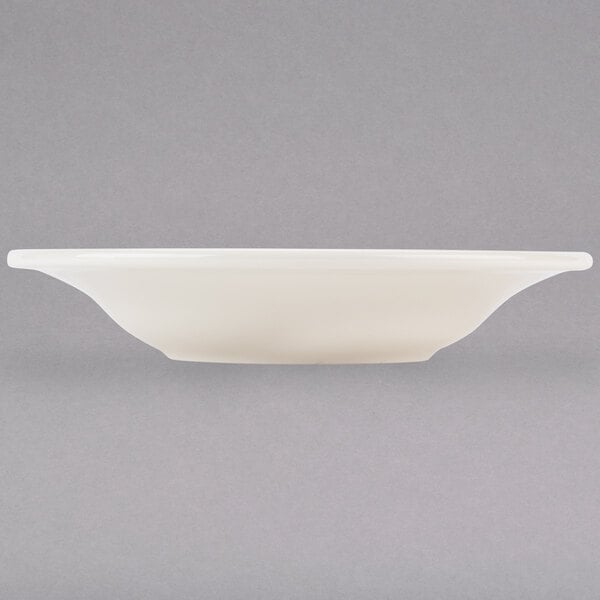 A white Tuxton Reno china bowl with a black rim on a white surface.