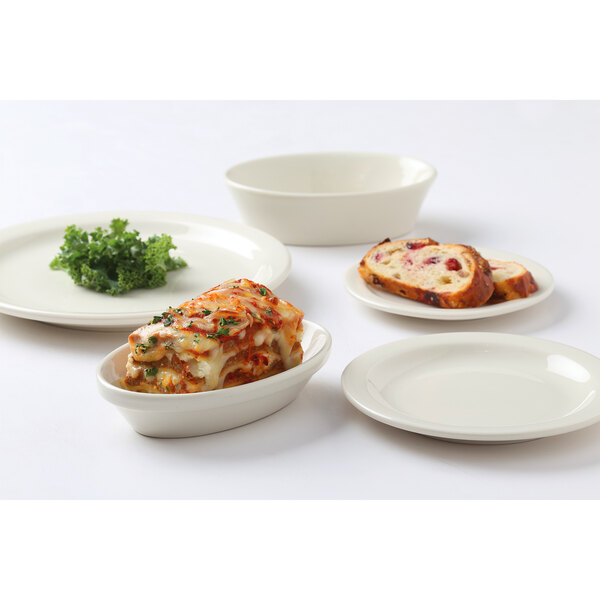 A Tuxton Nevada ivory china plate with lasagna on it.