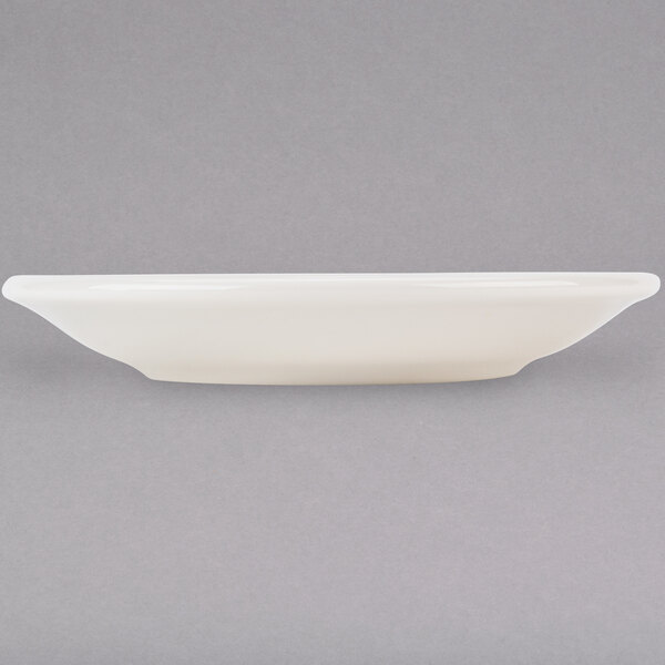 A white Tuxton Reno saucer on a gray surface.