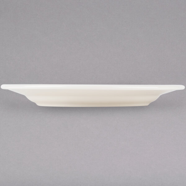 A Tuxton Reno ivory china plate with a wide rim.