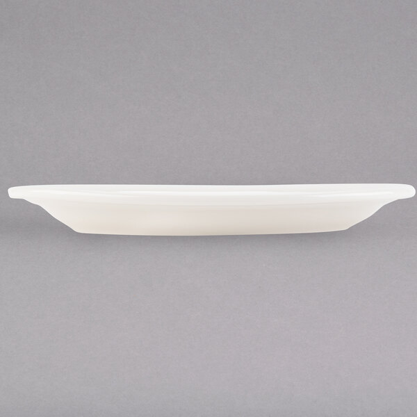 A white Tuxton oval china platter on a white surface.
