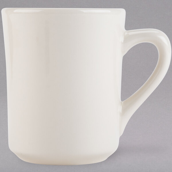 A Tuxton white china mug with a handle.