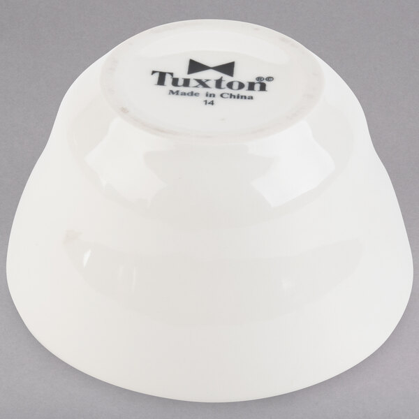 A white Tuxton China bowl with the word "Tuxton" in black.