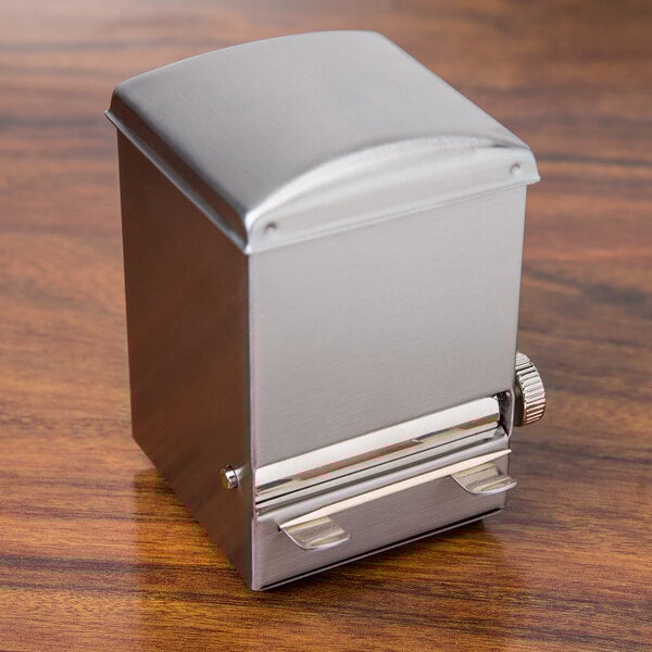 A Tablecraft stainless steel toothpick dispenser on a wood table.