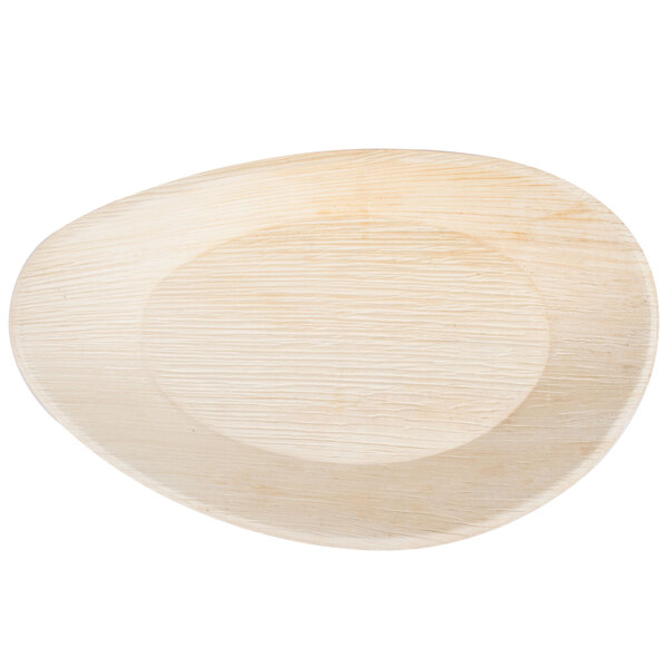 A close up of a TreeVive by EcoChoice oval palm leaf tray.