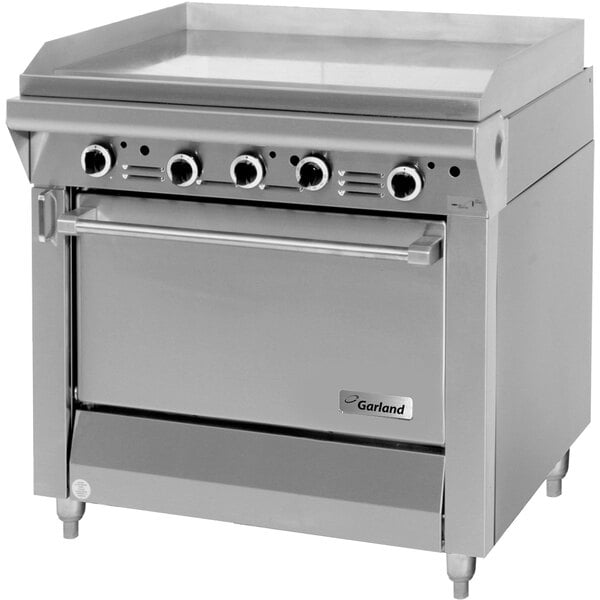 A large stainless steel Garland gas range with a griddle and standard oven.