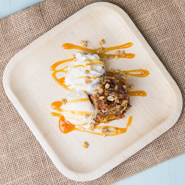 An EcoChoice square palm leaf plate with dessert and ice cream on it.