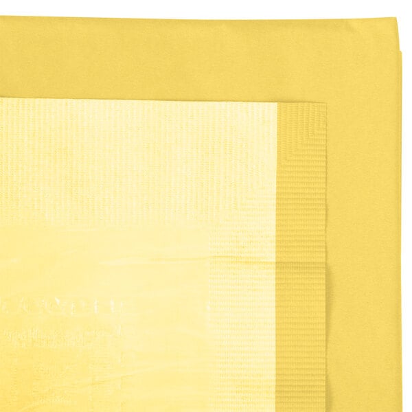 A yellow rectangular table cover with a white border.