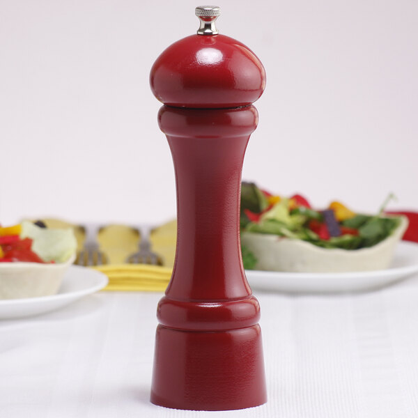 A Chef Specialties candy apple red salt mill on a table.