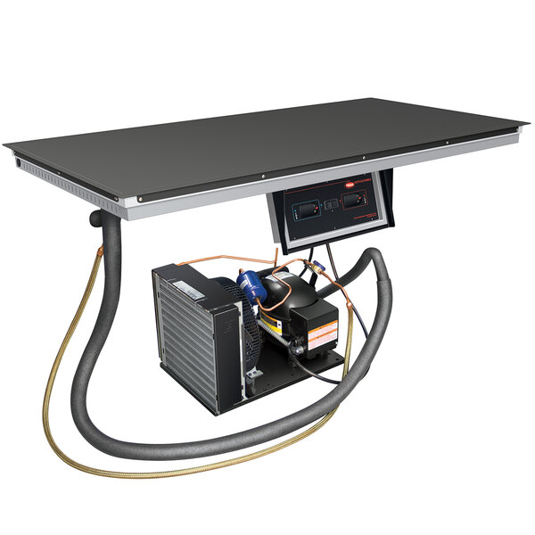 An aluminum Hatco built-in top-mount hot and cold shelf on a table in a bar.