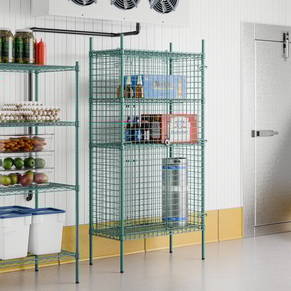 A Regency green wire security cage with shelves.