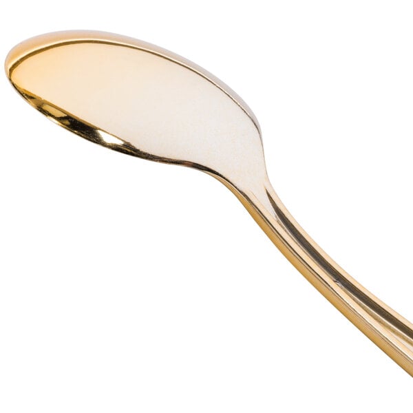 A close up of a Fineline gold plastic spoon with a white background.