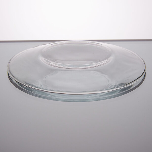 A Libbey clear glass salad plate with a circular edge.