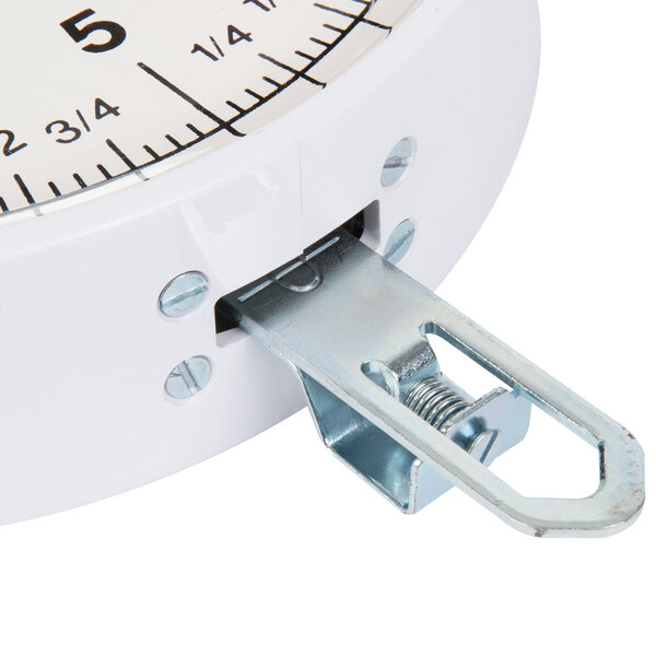 A Cardinal Detecto hanging scoop scale with a metal handle and stand.