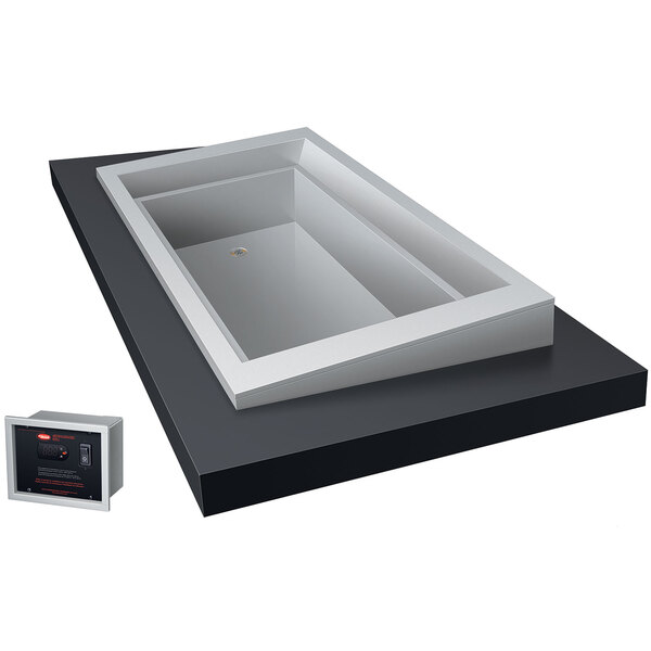 A white rectangular metal box with a clear rectangular surface and a black box with red text inside.