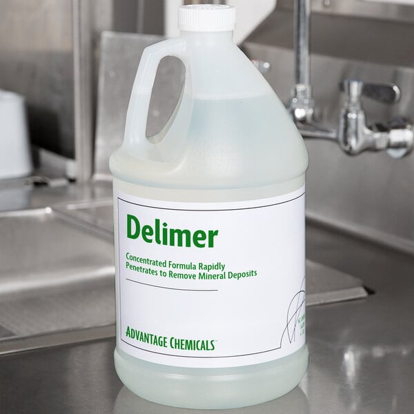 A white jug of Advantage Chemicals Delimer on a counter.