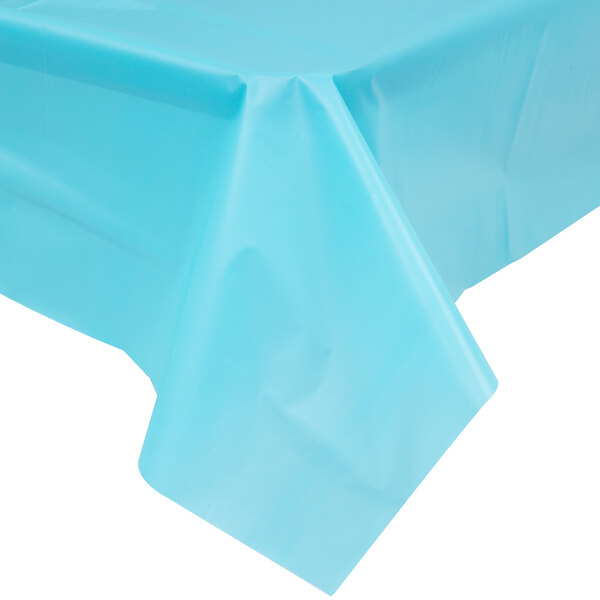 A Bermuda Blue plastic tablecloth on a table with a blue background.