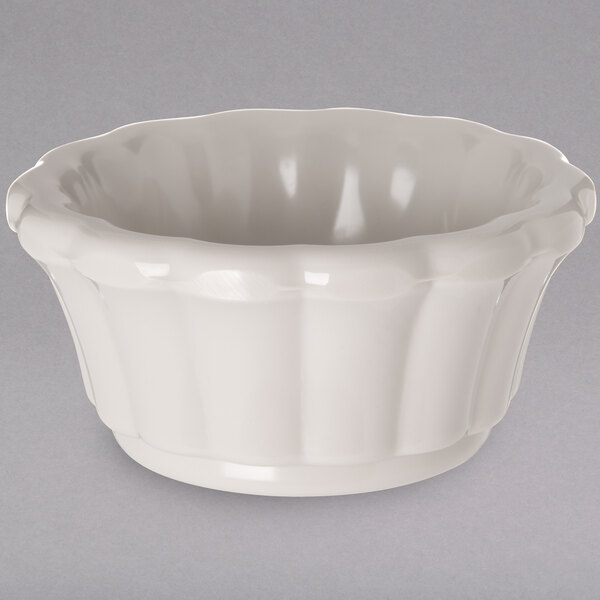 a white bowl with a scalloped edge
